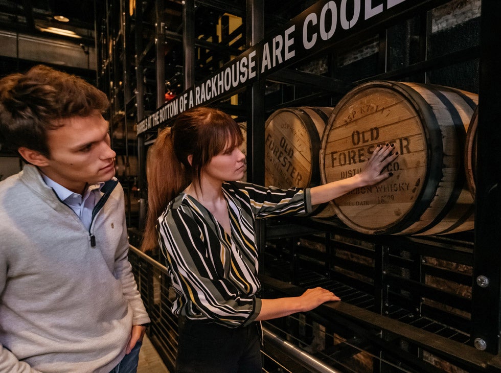 Old Forester tour guest touching barrel