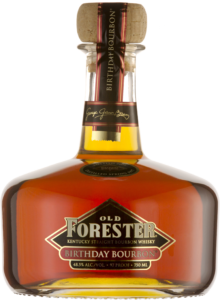 A bottle of Old Forester 2009 Birthday Bourbon on a black background.