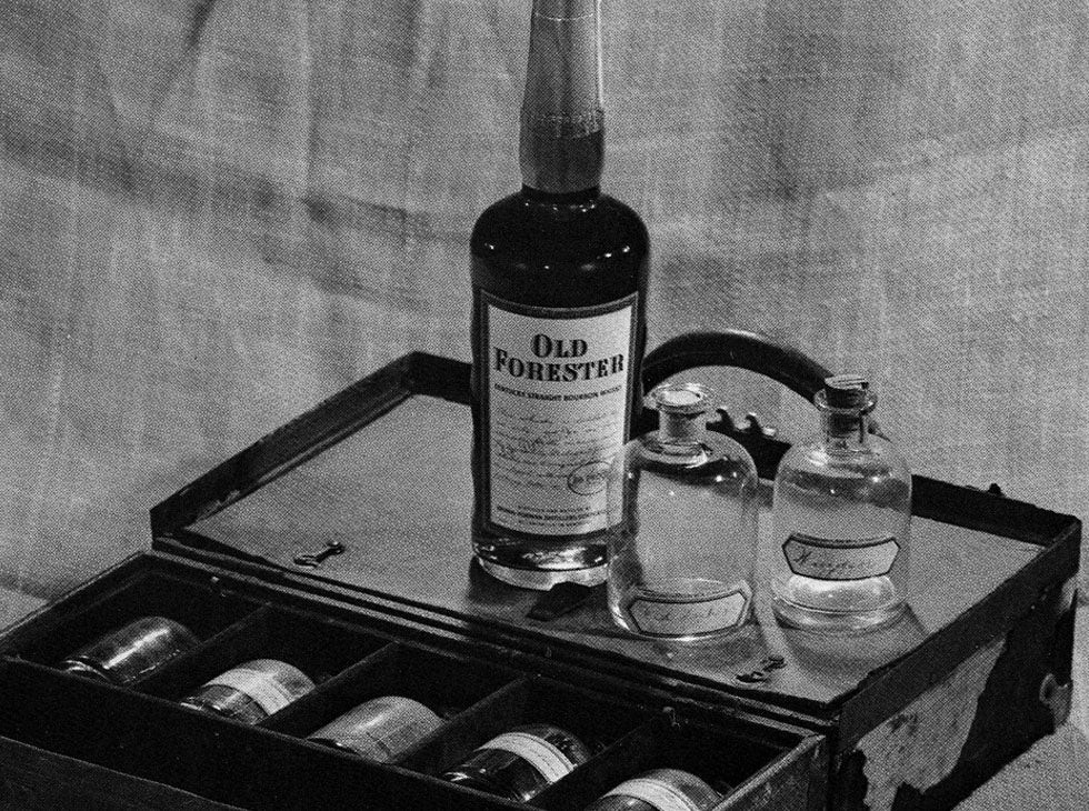 Old Forester bottles in suitcase